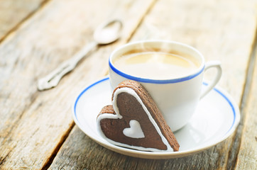 cup of coffee with the chocolate cookies in the shape of a heart