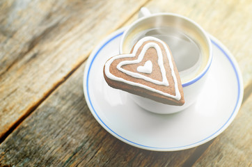 cup of coffee with the chocolate cookies in the shape of a heart