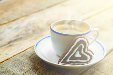 cup of coffee with the chocolate cookies in the shape of a heart