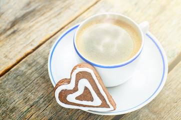 cup of coffee with the chocolate cookies in the shape of a heart