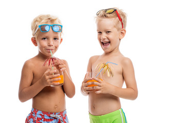 Two happy boys in sunglasses standing together, isolated on whit