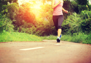  Runner athlete running on forest trail 