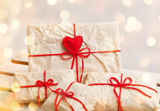 Gift boxes and hearts on white wooden background