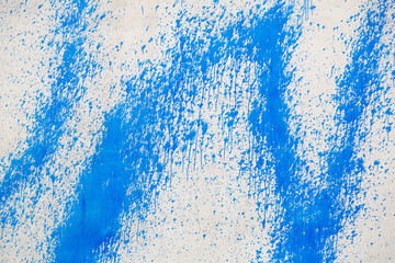 Naklejka premium Concrete wall with blue paint splatters