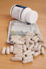 medicine on table with EURO money