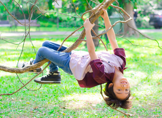 Little boy climb on a tree robe