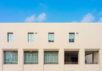 Fototapeta premium Conceptual image of a building and glass windows with blue sky