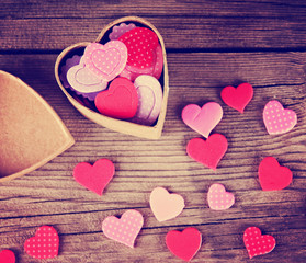 a valentine's day heart on a wooden background toned with a retro filter