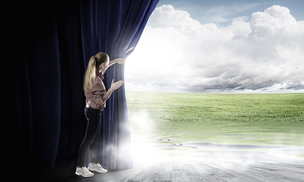 Girl opening curtain
