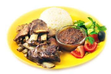 the rack of lamb with rice and sauce on the yellow plate