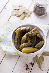 Marinated cucumbers on wooden background