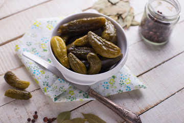 Marinated cucumbers on wooden background