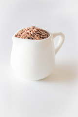 Ceramic pitcher of brown flaxseed