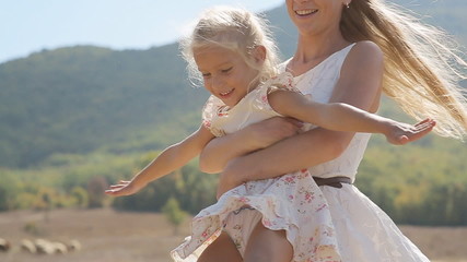 Close up of young mother circling her little daughter in slow - Powered by Adobe