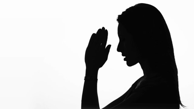 Closeup Profile Of A Woman Praying In Silhouette Isolated