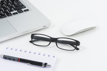 Blank business laptop, mouse, pen, glasses and note