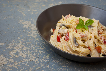 Fresh pasta with mushrooms on vintage background