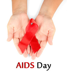AIDS ribbon in hands isolated on white