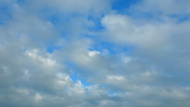 Time lapse clip of white clouds over blue sky