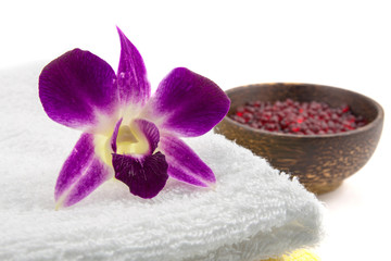 Spa and wellness setting with flowers and towel