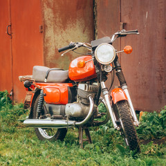 Obraz premium Vintage Red Motorcycle Generic Motorbike In Countryside