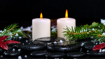 winter spa concept of evergreen branches with drops, snow,  cand