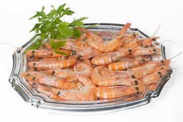 Tray of cooked prawns on white background