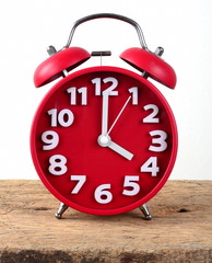 red alarm clock, showing time