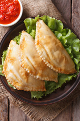 Traditional empanadas and sauce closeup. vertical top view