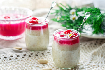 Rice pudding with almonds, whipped cream and cherry sauce