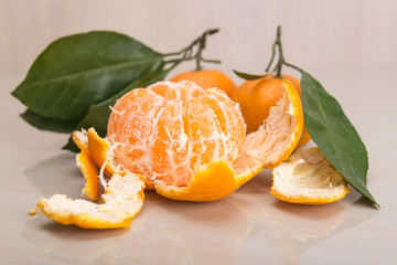 mandarin or tangerine with leaves and branches on a marble table