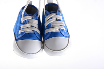 Baby sneakers on wood background