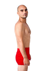 Portrait of a fit athletic man in red underwear isolated.