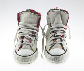 Old sneakers isolated on white background.