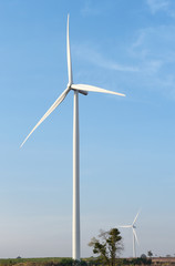 Fototapeta premium wind turbine against cloudy blue sky background