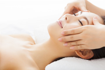 massage of face for woman in spa salon