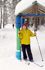 An old woman skiing in the forest