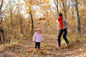 Mother Throwing Leaves on Daughter