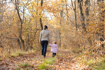 Obraz premium Mother and Daughter Walking in Forest