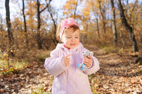 Girl Talking with Toy Mouse