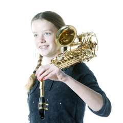 blond teenage girl holds saxophone in studio