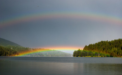 Double rainbow over a mountain lake.