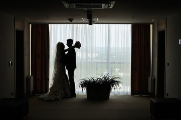 silhouettes of groom and bride