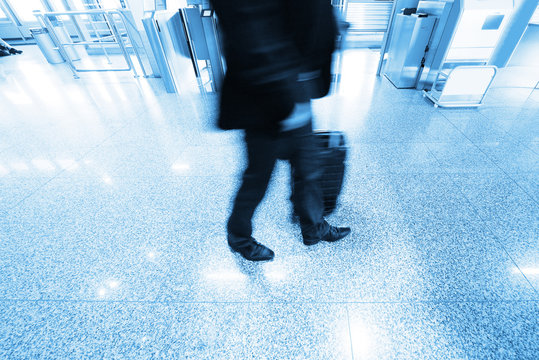 Man walking with bag in airport terminal
