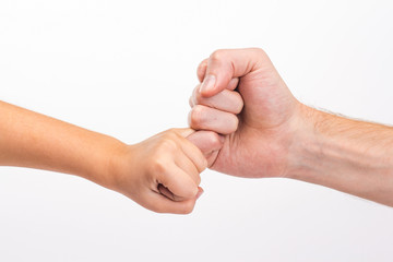 male hand holding the little finger of the child