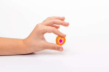 Children's hand holding a heart