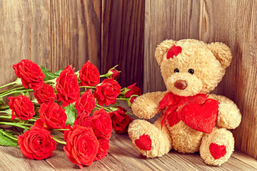 Valentines Day. Teddy Bear Loving with bouquet of Red Roses