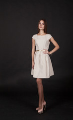 young beautiful girl in a bright dress posing standing