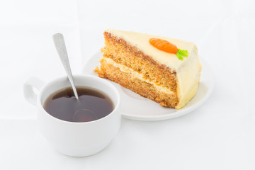 Carrot Cake on white dish with hot drink
