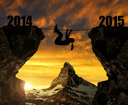 Girl climbs into the New Year 2015. In the background Matterhorn
